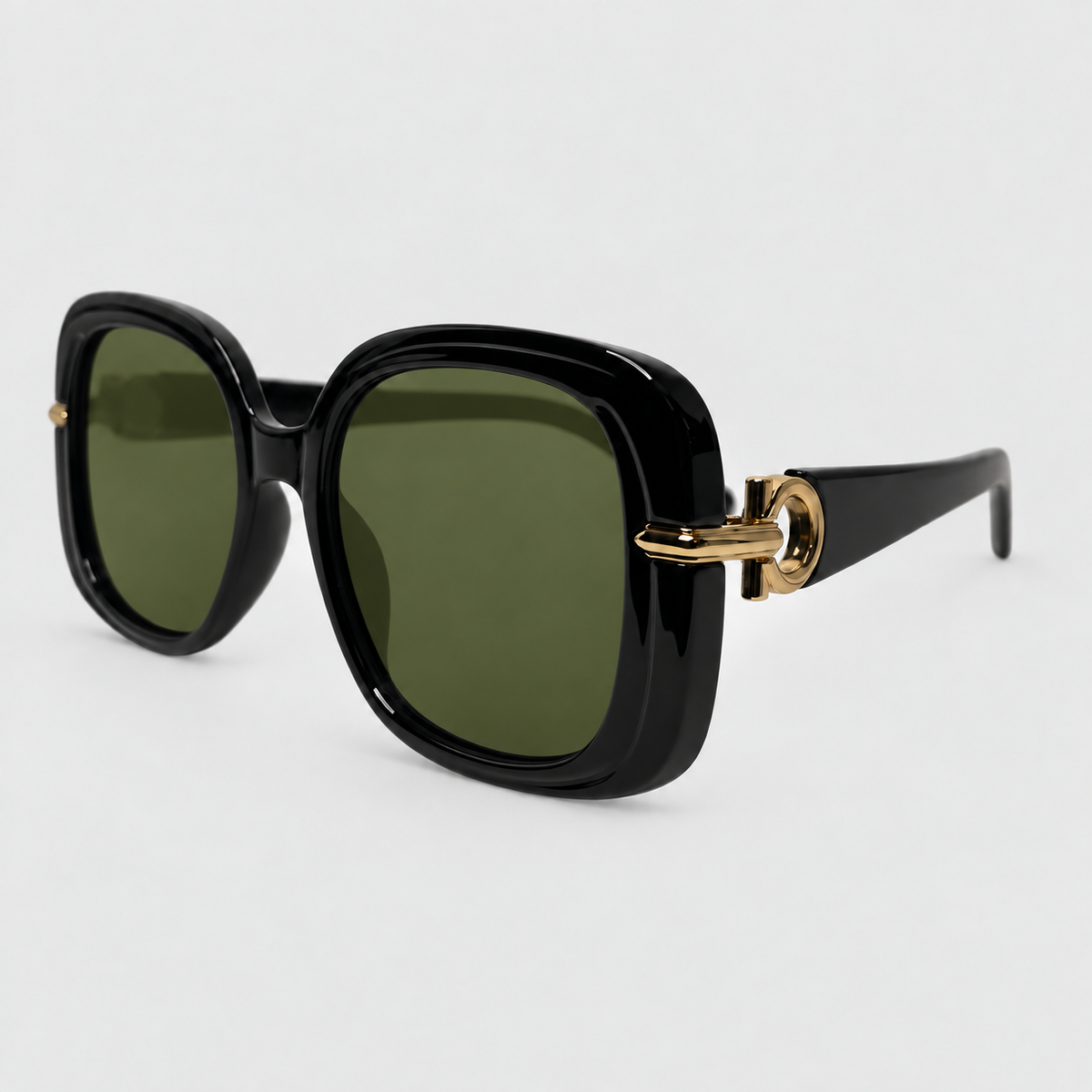 Oversized square sunglasses with a glossy black frame, olive green lenses, and a gold metal accent on the side temple arm, shown on a light gray background.