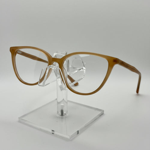 Brown eyeglasses on a clear stand against a white background
