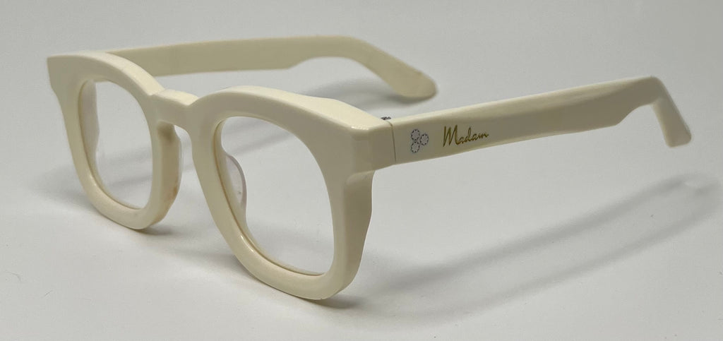 Beige eyeglasses on a light gray background