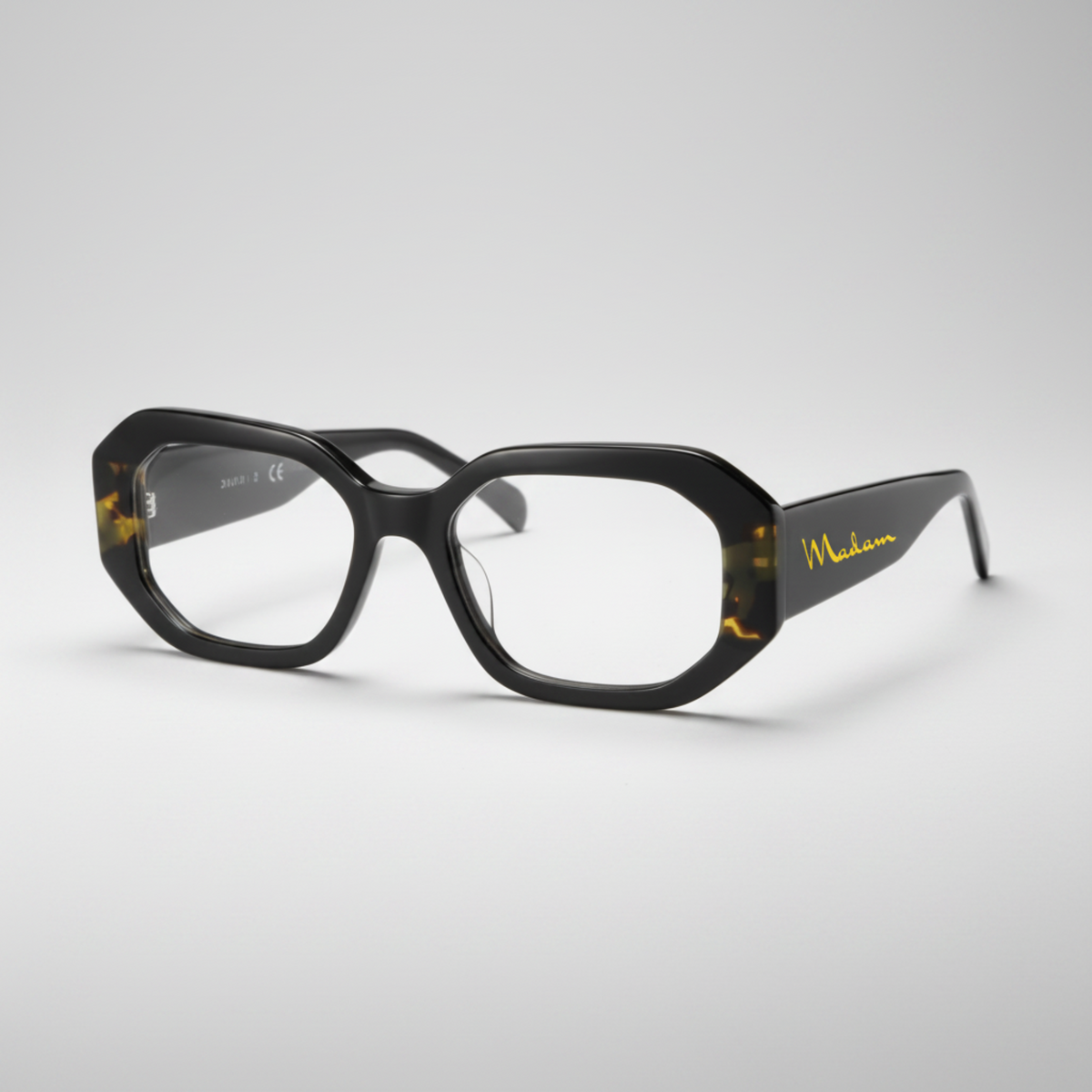 Black eyeglasses with gold accents on a white background