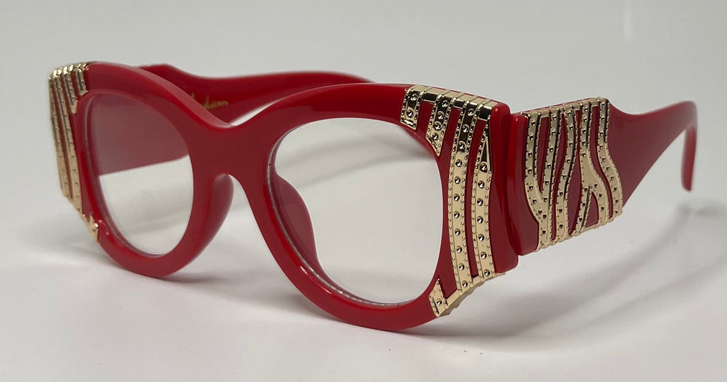 Red eyeglasses with gold and black decorative elements on a white background