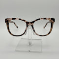 Tortoiseshell eyeglasses on a clear stand against a white background