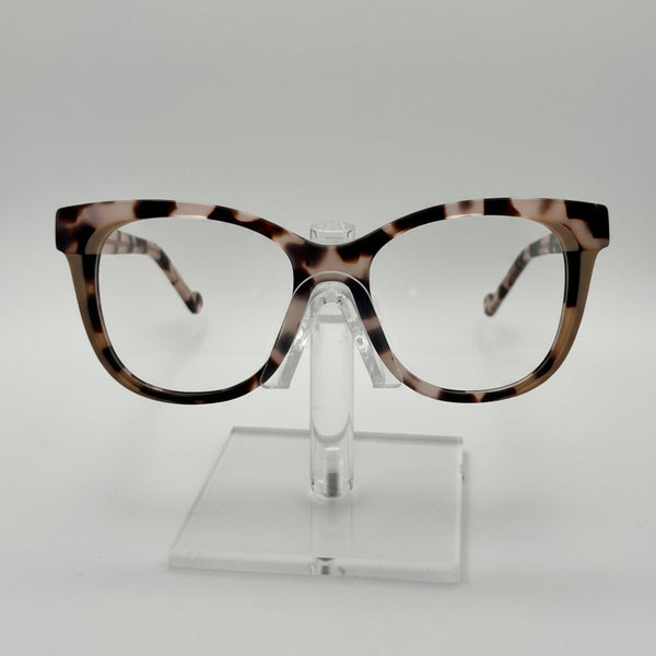 Tortoiseshell eyeglasses on a clear stand against a white background