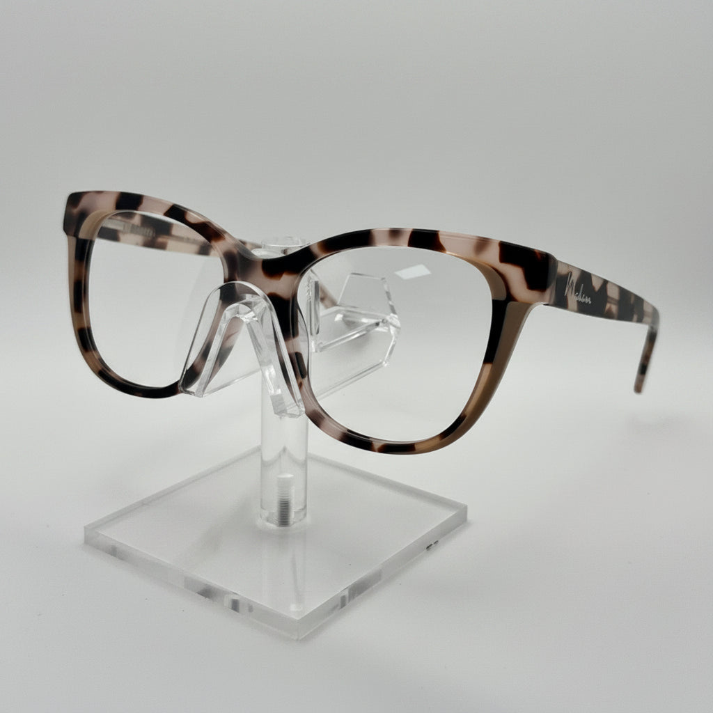 Eyeglasses with tortoiseshell frame on a clear stand against a white background