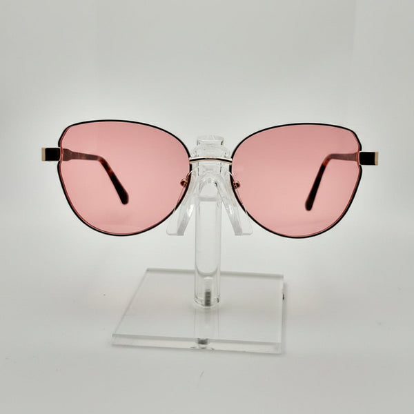 Pink sunglasses on a clear stand against a light gray background