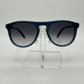 Sunglasses on a clear stand against a gray background