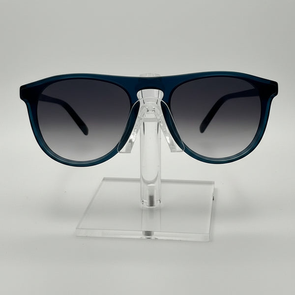 Sunglasses on a clear stand against a gray background