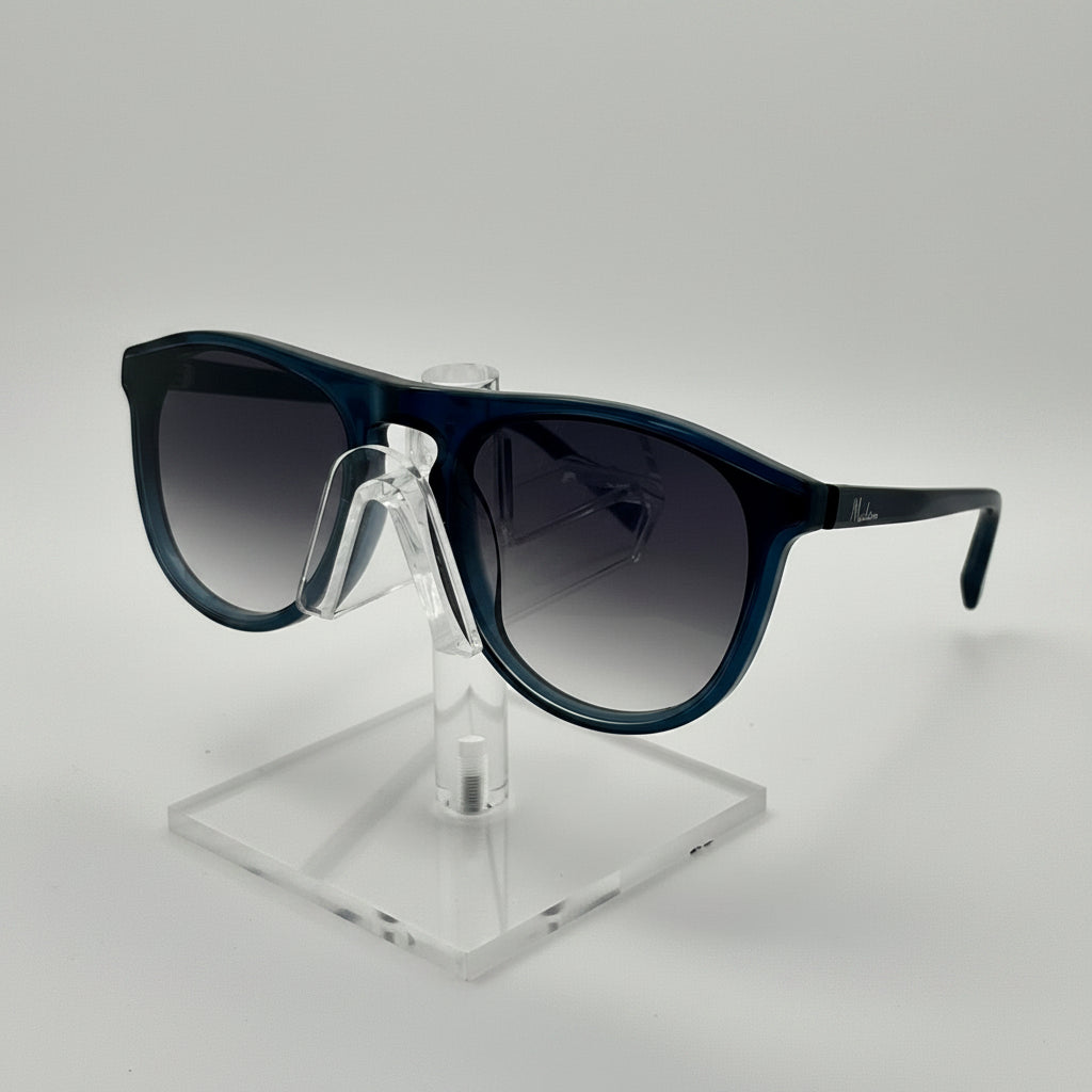 A pair of oversized square sunglasses with dark gradient lenses and a glossy black frame, displayed on a clear acrylic stand against a light gray background.