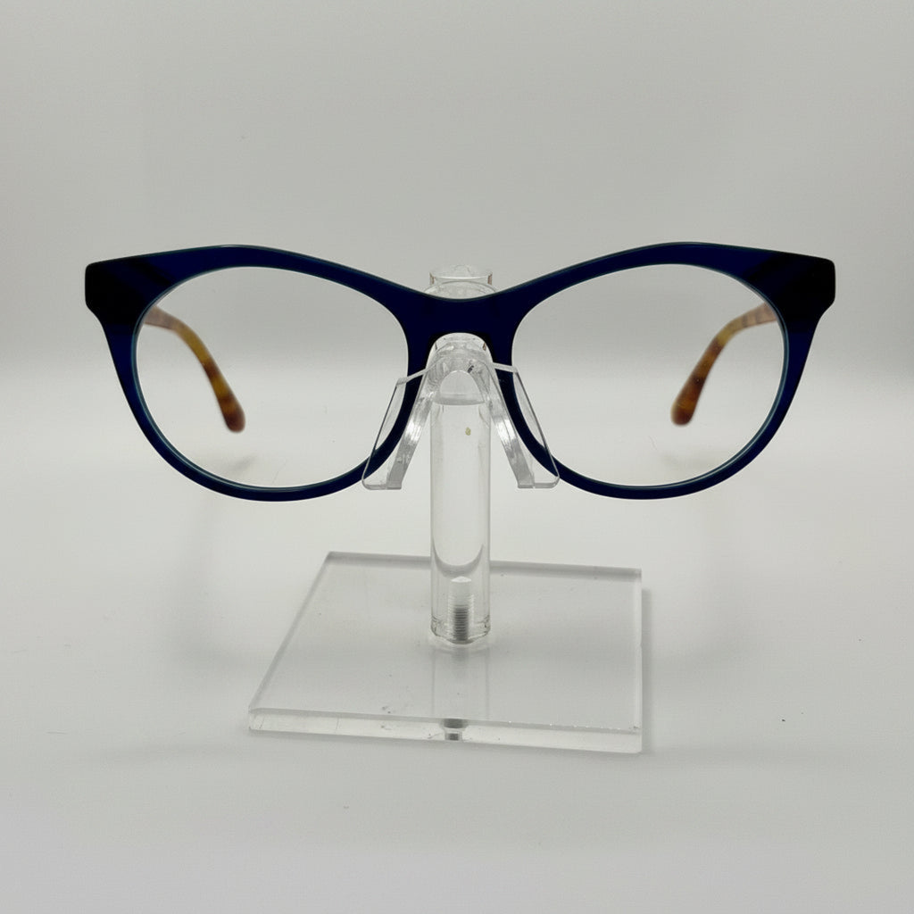 round eyeglasses with a dark navy blue frame and clear lenses, displayed on a transparent acrylic stand against a light gray background.