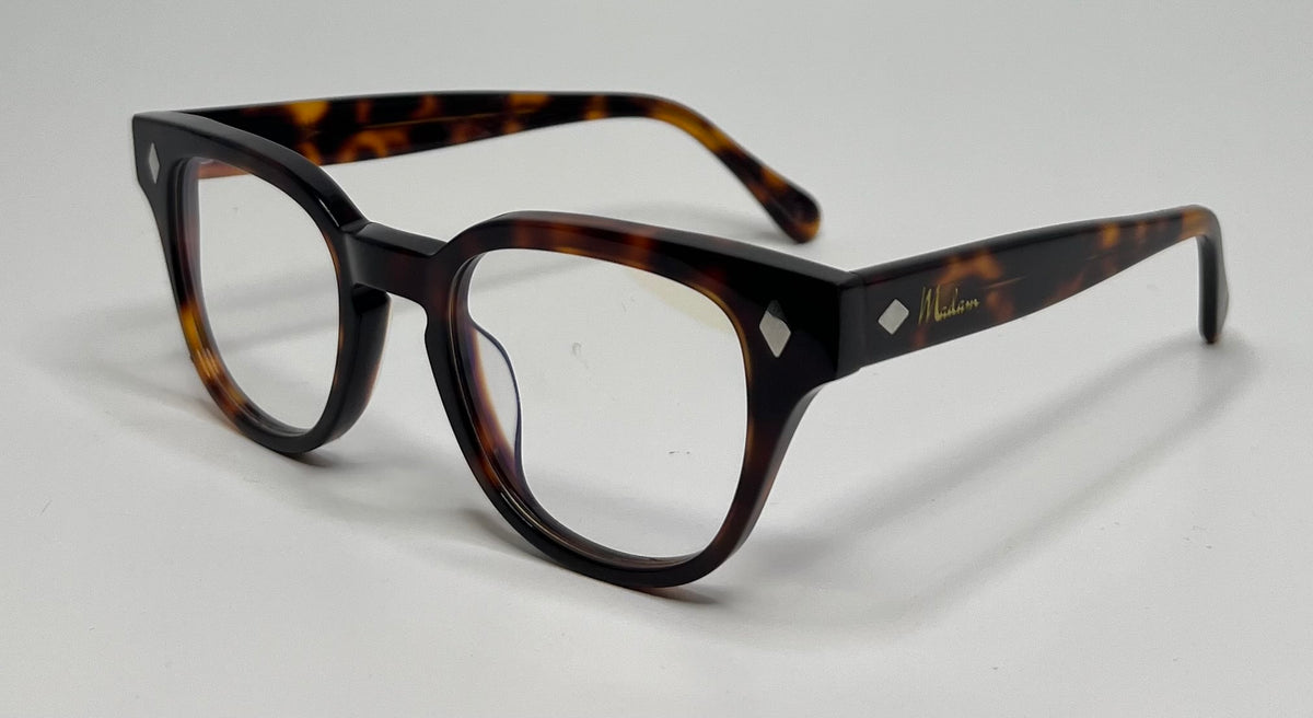 Tortoiseshell eyeglasses on a light gray background