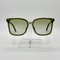 Green sunglasses on a clear stand against a white background