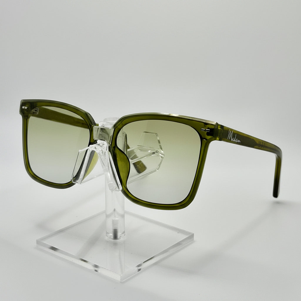 Green sunglasses on a clear stand against a gray background